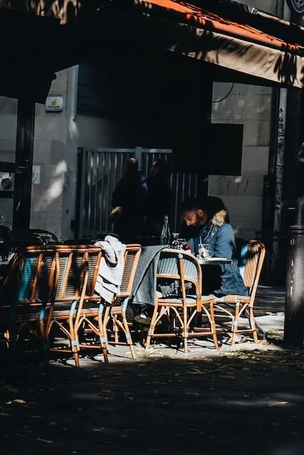A man has a coffee outside a cafe