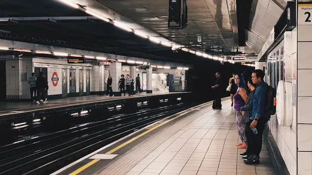 People wait for a train to arrive