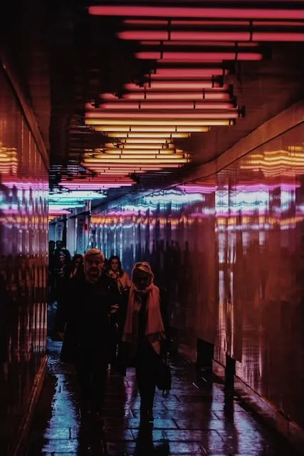 a temporary walkway lit by a warm spectrum of neon lights