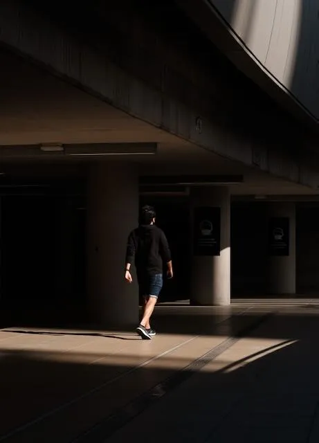 A man is lit within a small pat