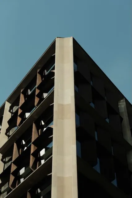 A minimalist view of a building against a blue sky.