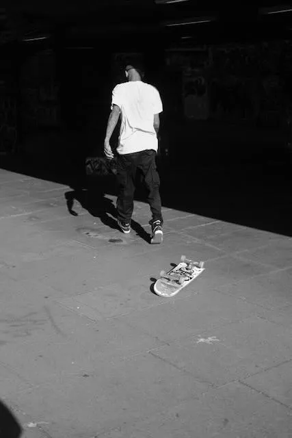 A man walks away from a failed skateboard trick