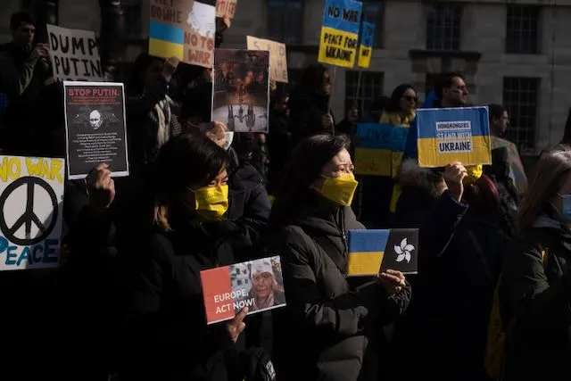 A group of protesters surrounded by Ukranian regalia