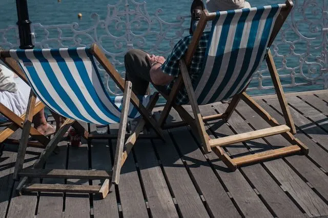 An unknown person lounges in a deckchair