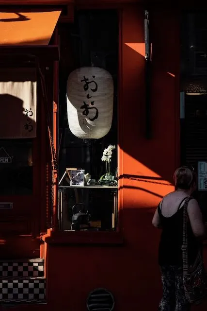 A paper lantern is seen through a shopwindow