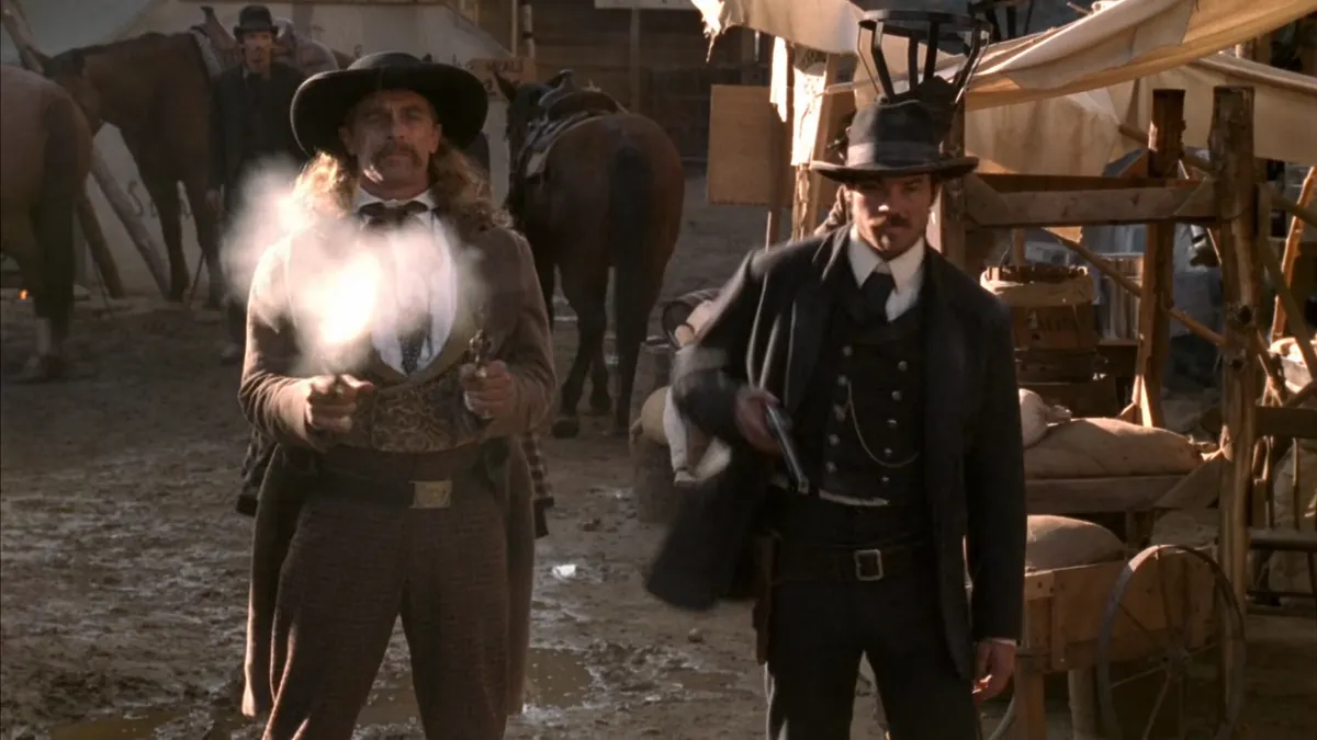 Hickok and Bullock drawing weapons in the street. Only Hickok has fired.