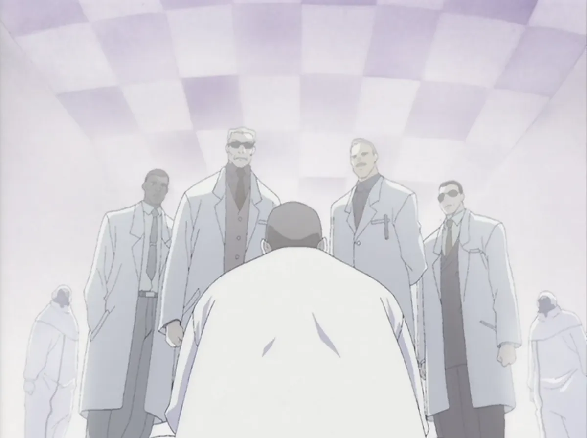 Pierrot in the lab, surrounded by imposing scientists in lab coats