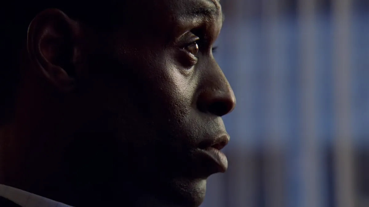 Later in the same shot, extreme profile close-up on Daniels, whose facial highlights bisect the frame