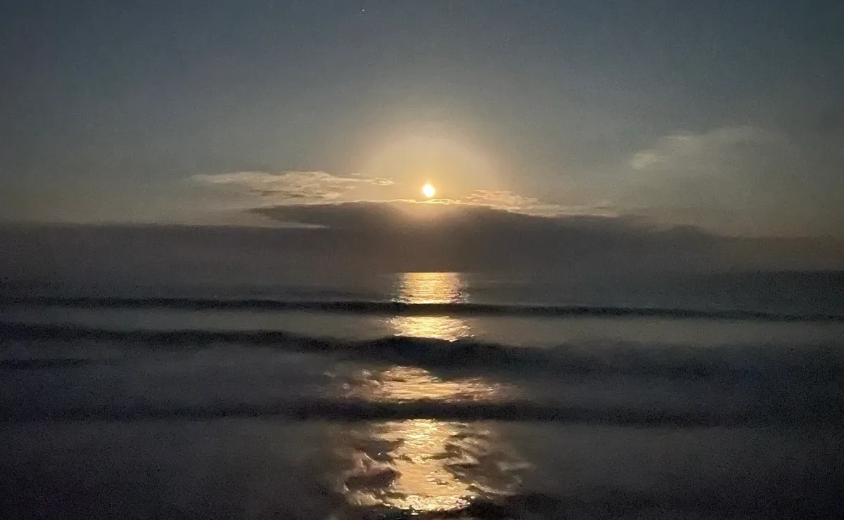 The moon rises over a beach on the Outer Banks of North Carolina.