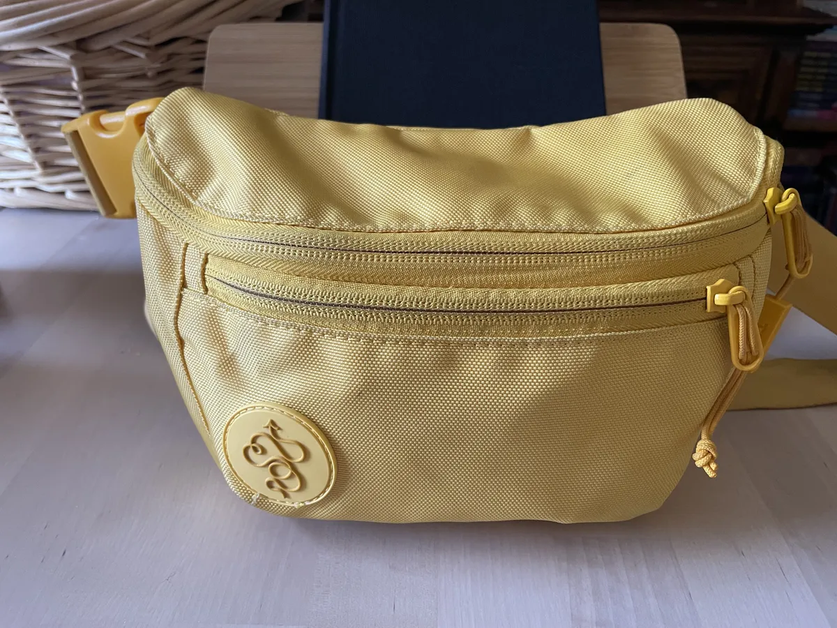 A bright yellow Baboon the Moon 3L belt bag.