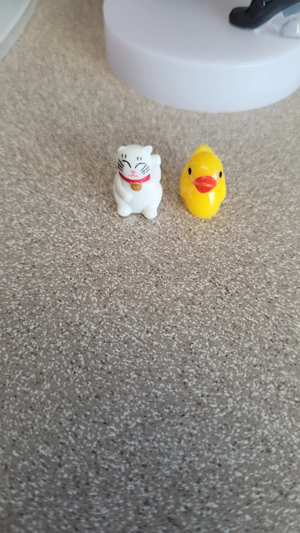 A tiny lucky cat and duck