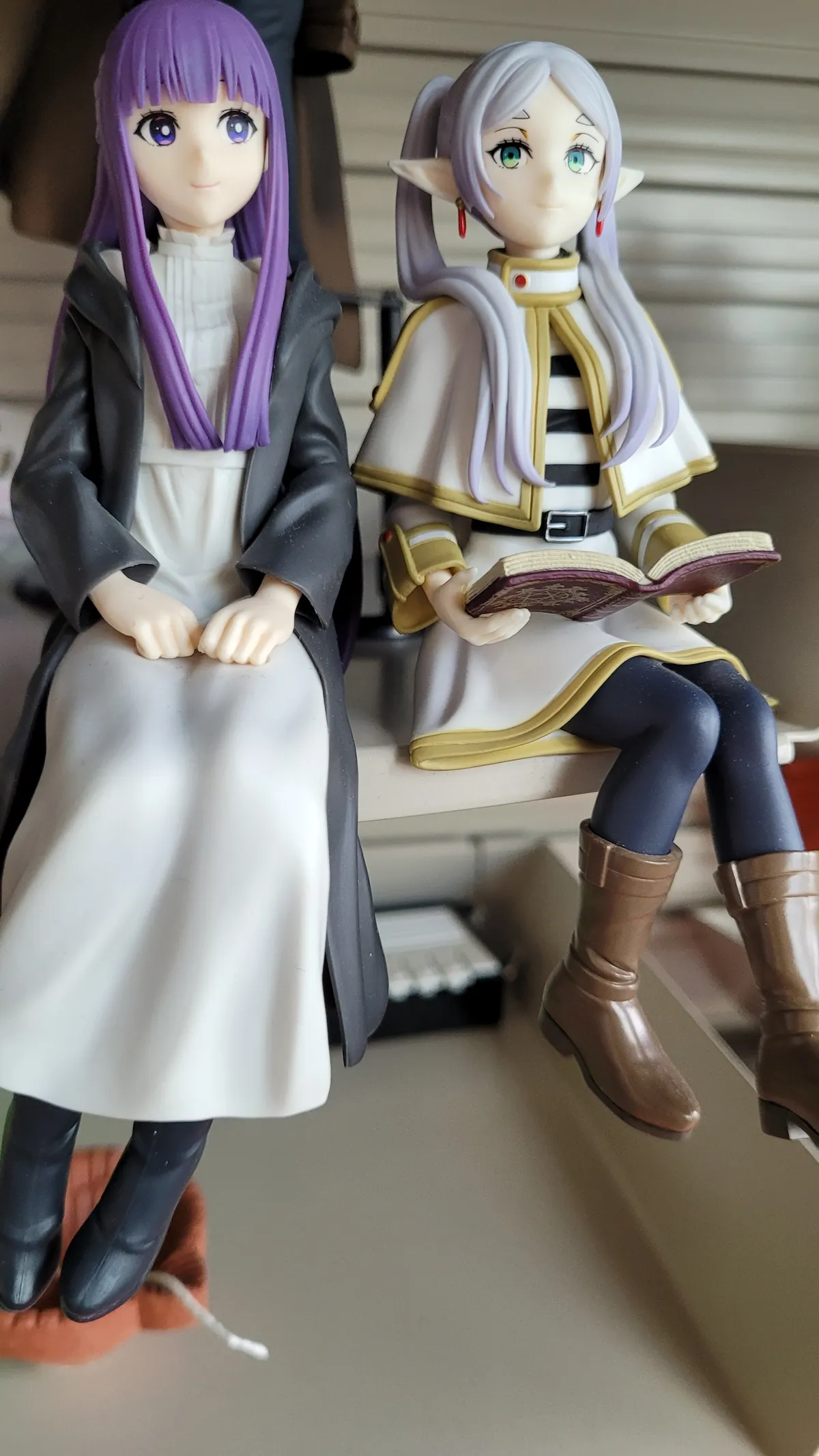 Anime figures on a shelf - Fern and Frieren