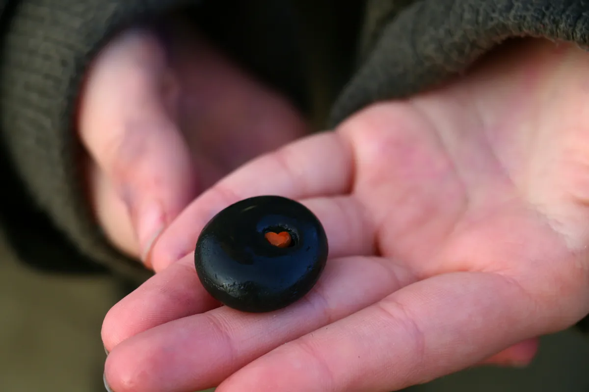 the heart stone A stone held in cupped hands appears to have a tiny heart embedded inside