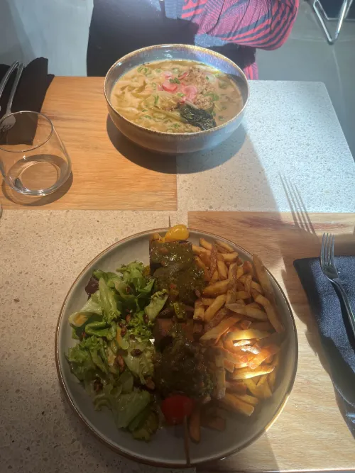 ramen and skewer with fries and salad