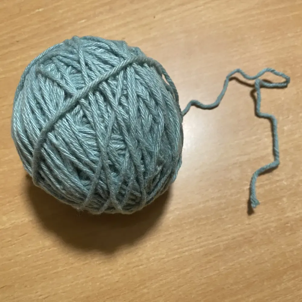 Ball of pale blue-green cotton yarn.
