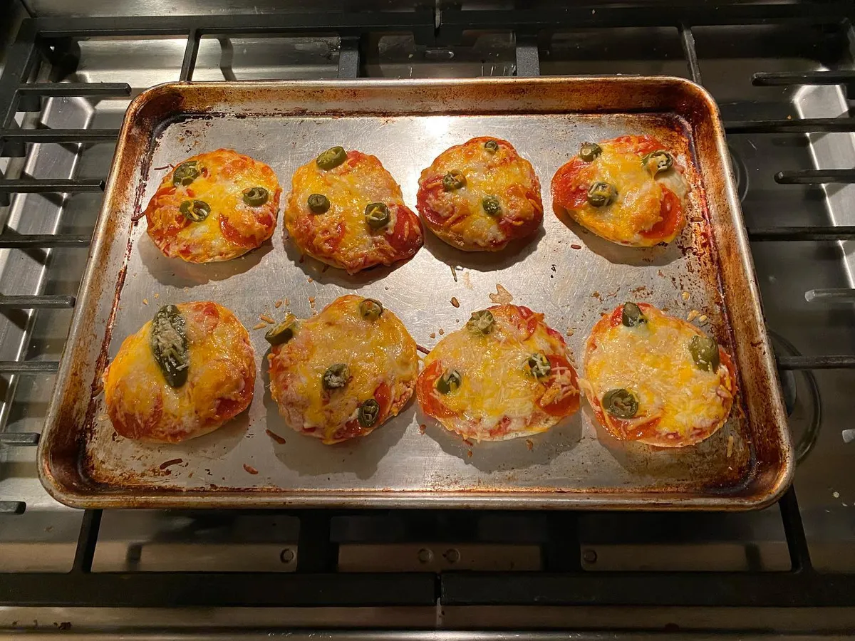Credit to my mom who introduced me to english muffin pizzas in elementary school. Tonight's variation was pepperoni and jalapeno slices.