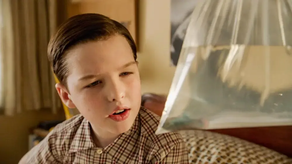 Sheldon holds Fish in a plastic bag full of water.