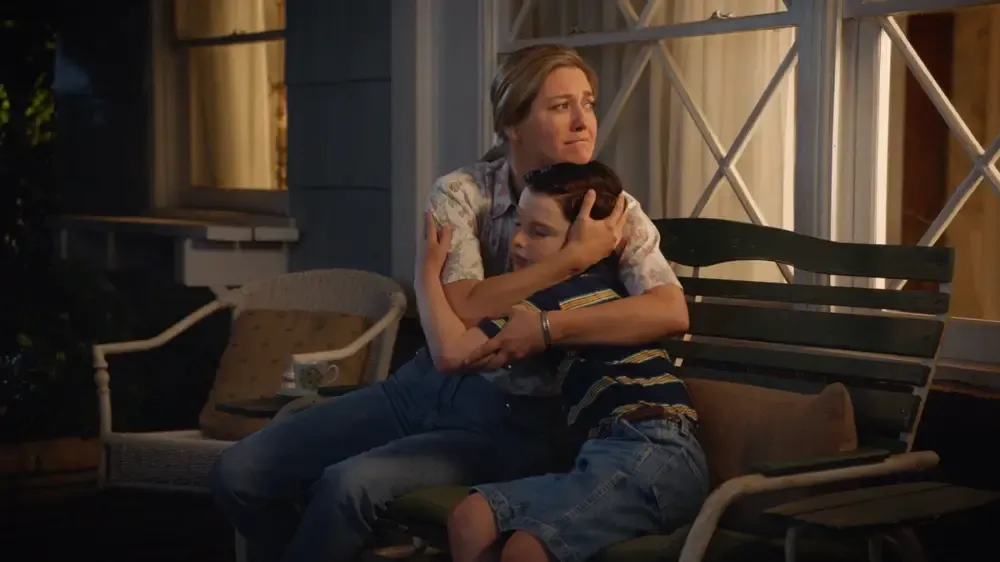 Mary embraces Sheldon as they sit on the front porch.