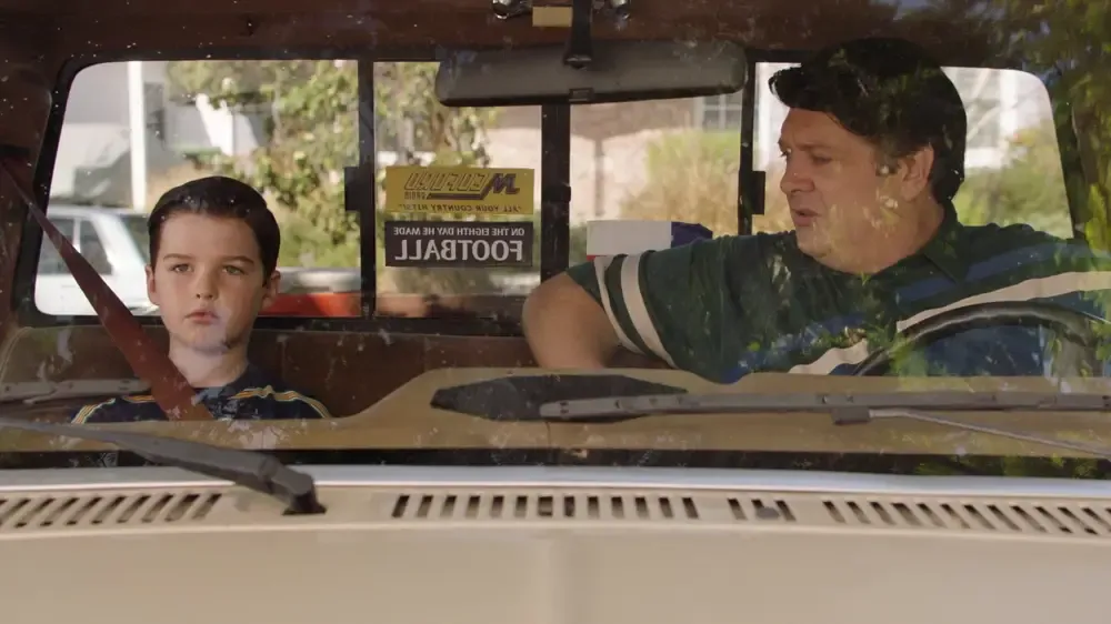 Sheldon talks to his dad in his truck.