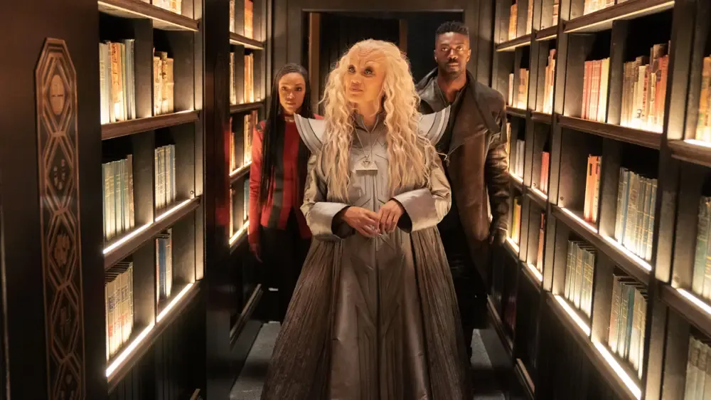 Burnham and Book accompany a librarian on the way to the next task.