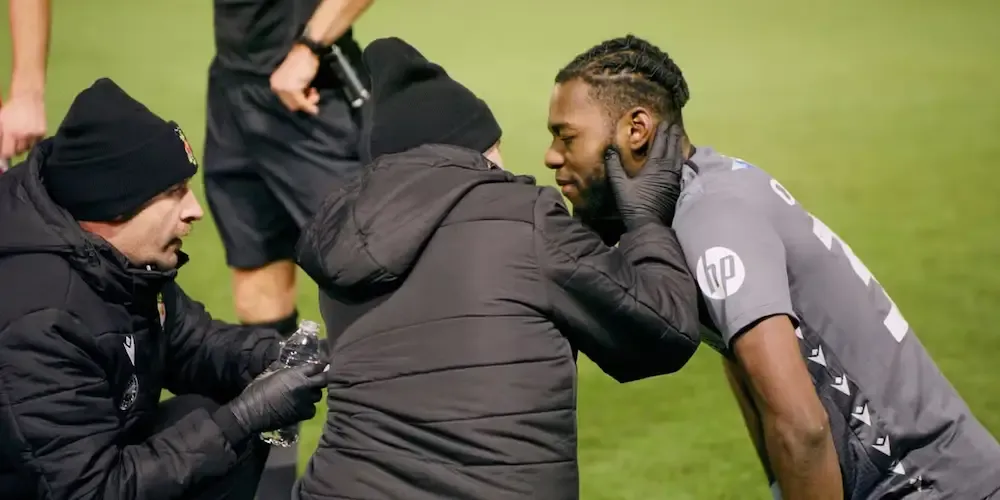 Arthur Ookwonko is attended to after the freak play that broke his jaw.