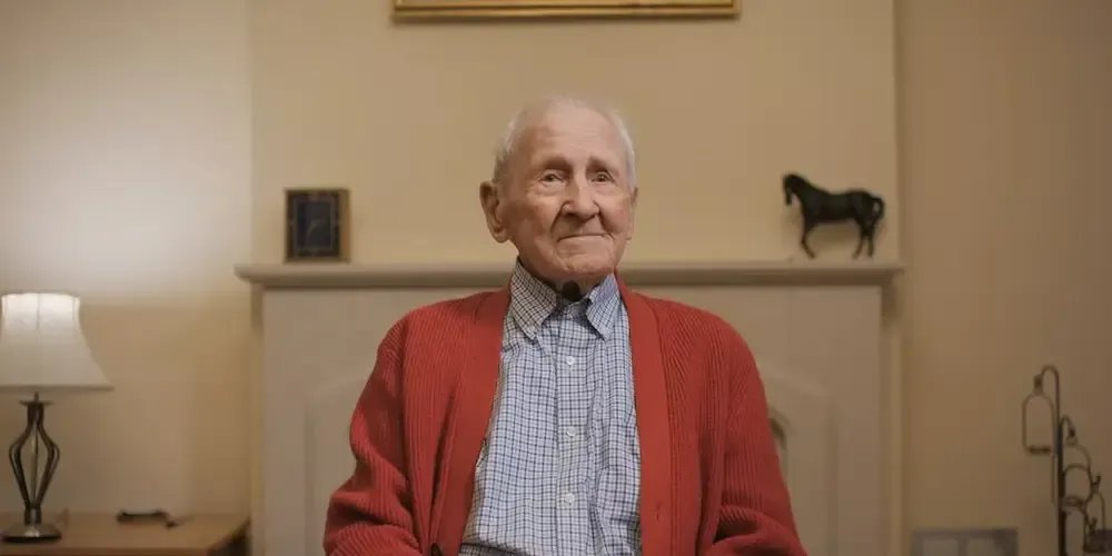 Arthur Massey sitting in his home.