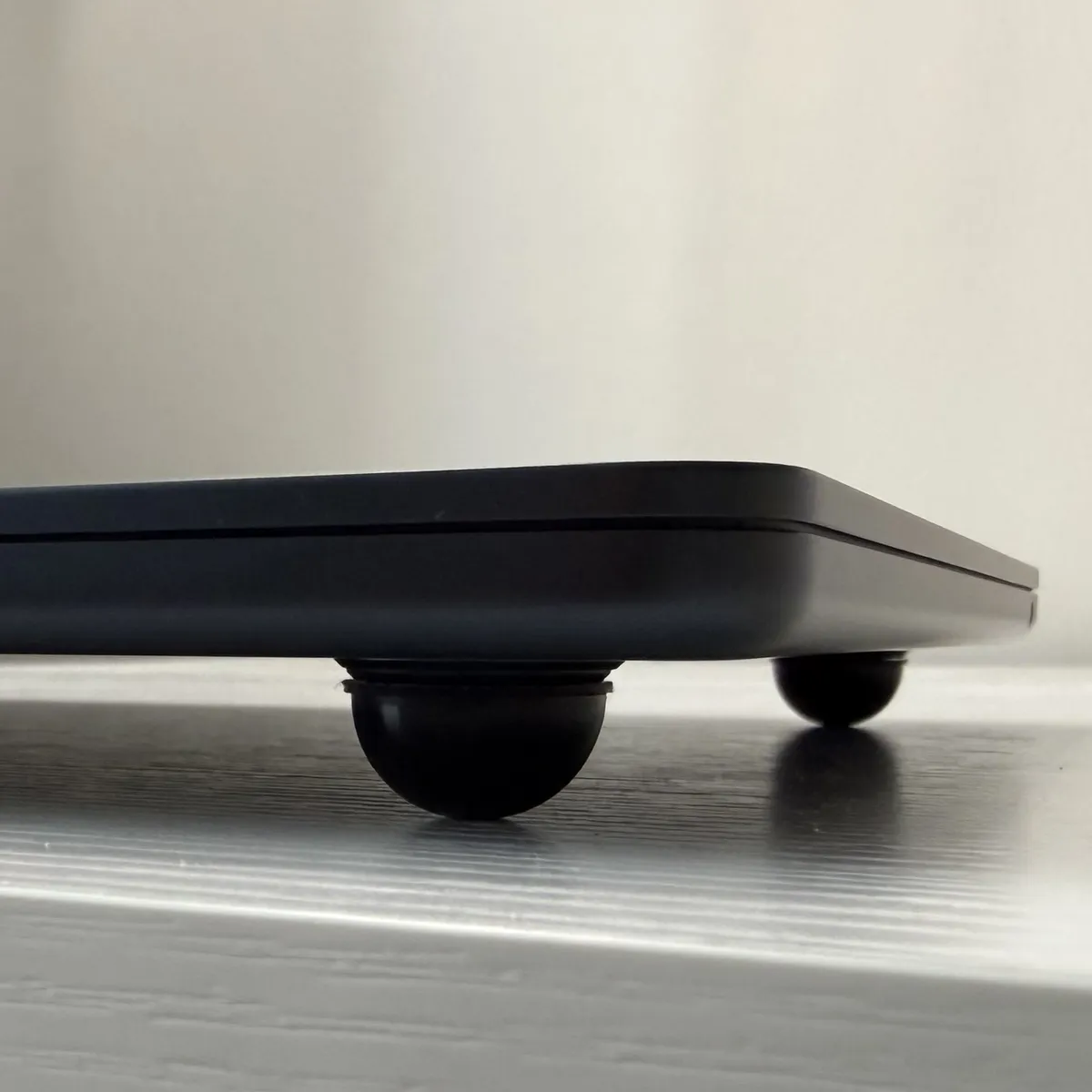 Up-close front view of a bumper attached to a rubber foot on my MacBook Air