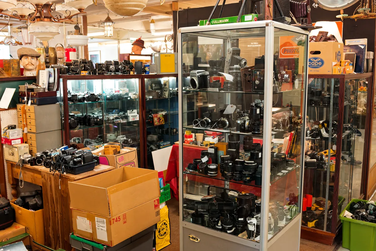 A selection of film and digital cameras on display in a market