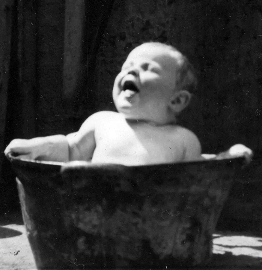Paul Murphy as a baby have a bath in an old zinc tub in 1954