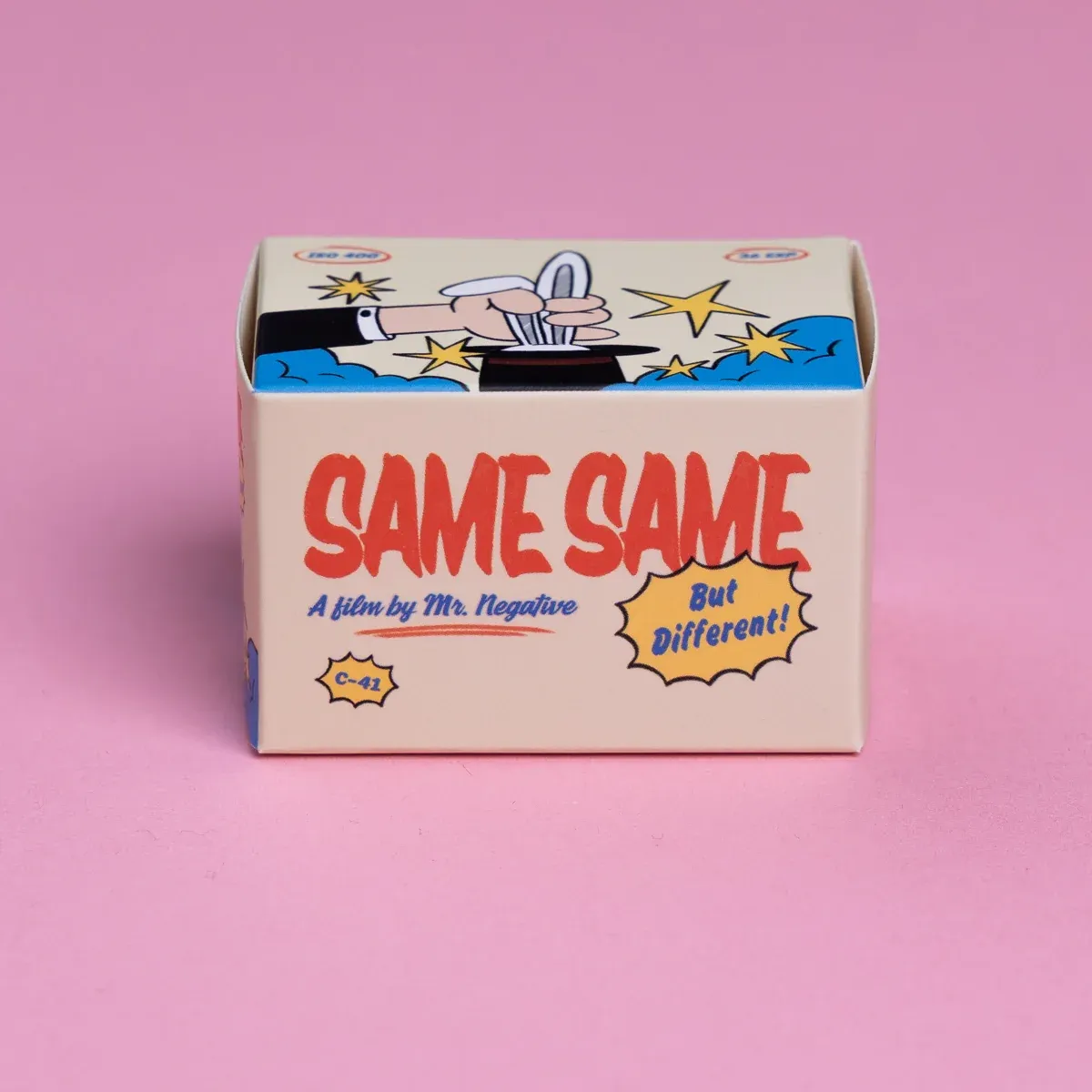 A box of Same Same film on a pink backdrop. The side of the box says: 