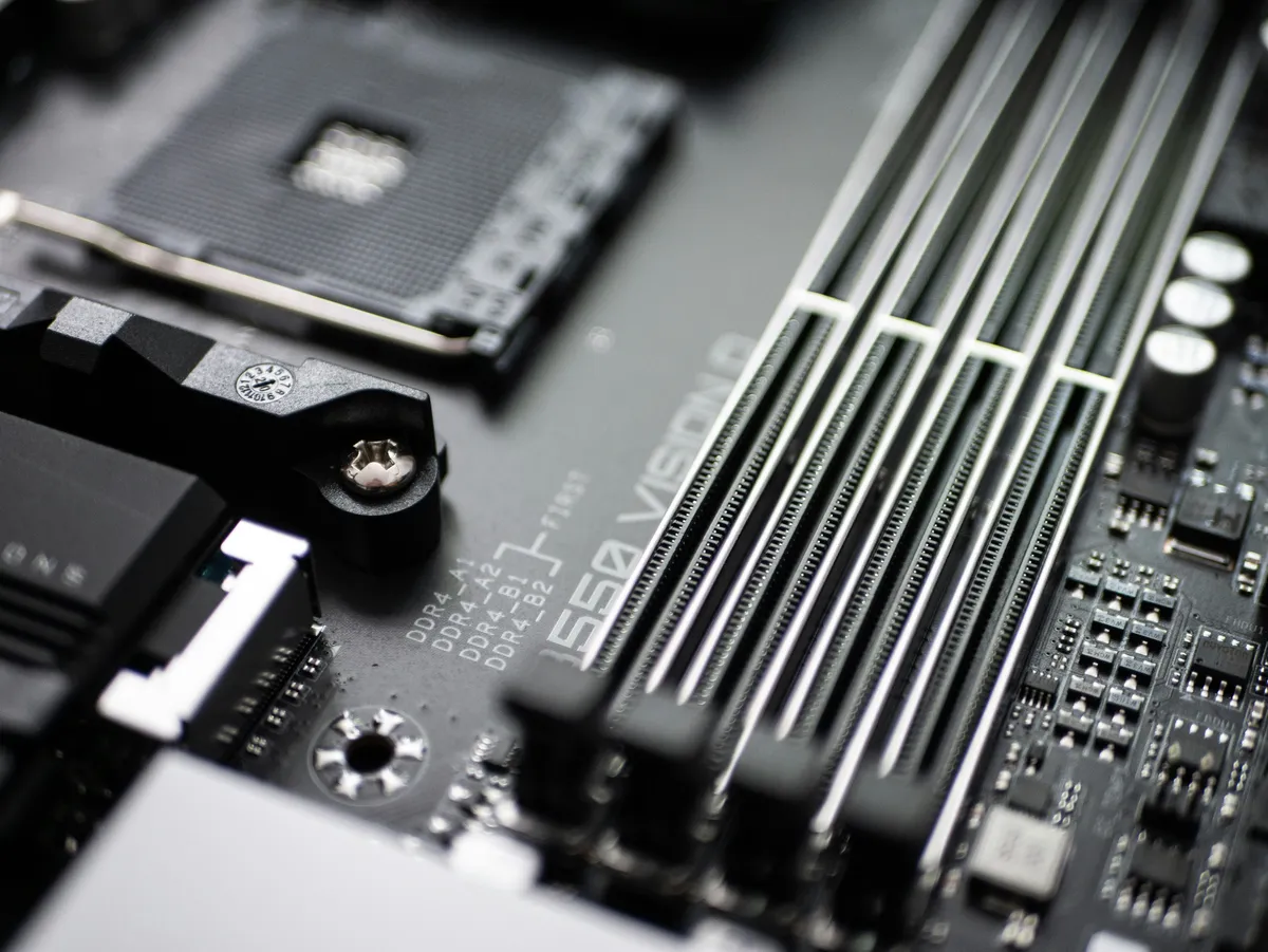A computer motherboard showing chips and sockets