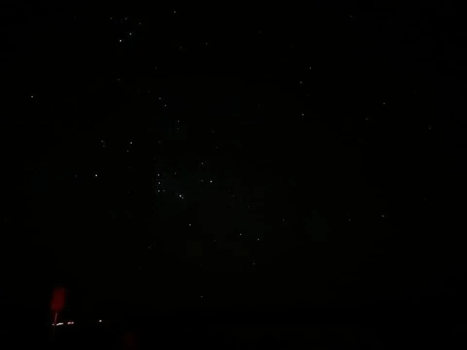 A night sky, with faint red light