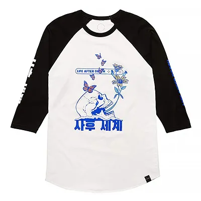 a longsleeve 'baseball' style white shirt with black sleeves and a skull with flowers graphic in the center