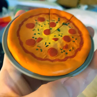 A doll-sized plastic pizza.