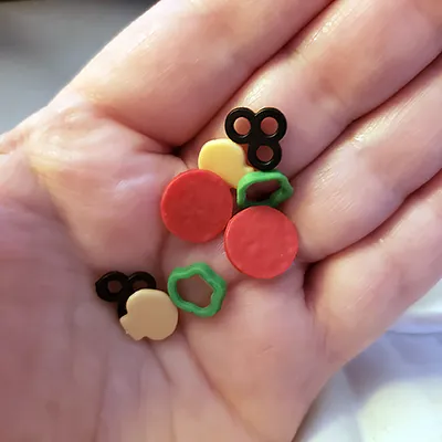 tiny plastic pizza toppings