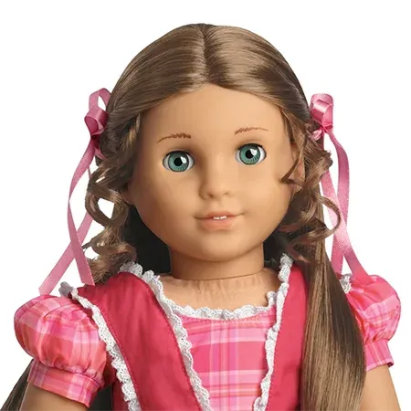 Marie-Grace, a caucasian doll with blue eyes, light brown hair, and a pink dress
