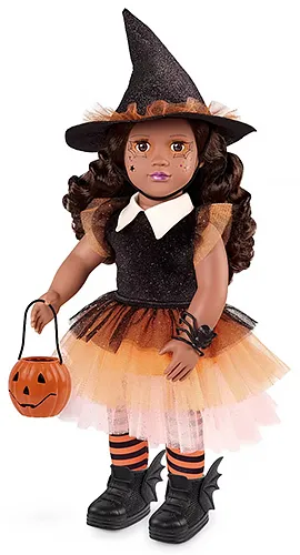an Our Generation brand doll in an orange and black witch costume, holding a jack-o-lantern bucket