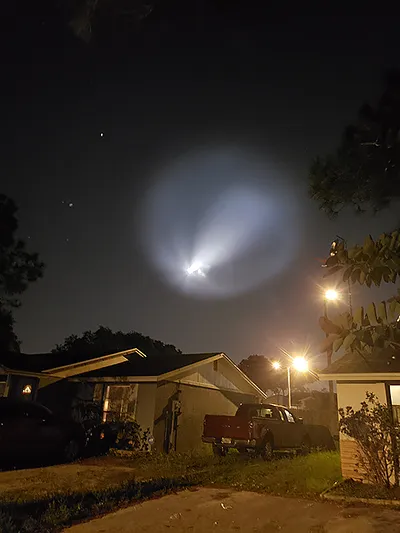 SpaceX Rocket carrying Crew Dragon Capsule 'Endeavour' glows brightly in the otherwise dark Eastern sky
