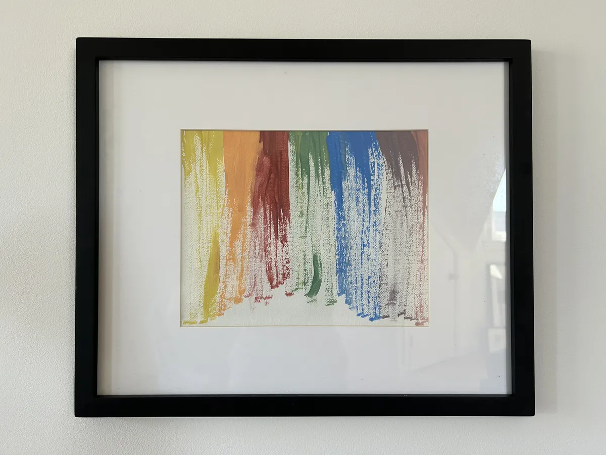 A painting of a rainbow created with rough brush strokes.