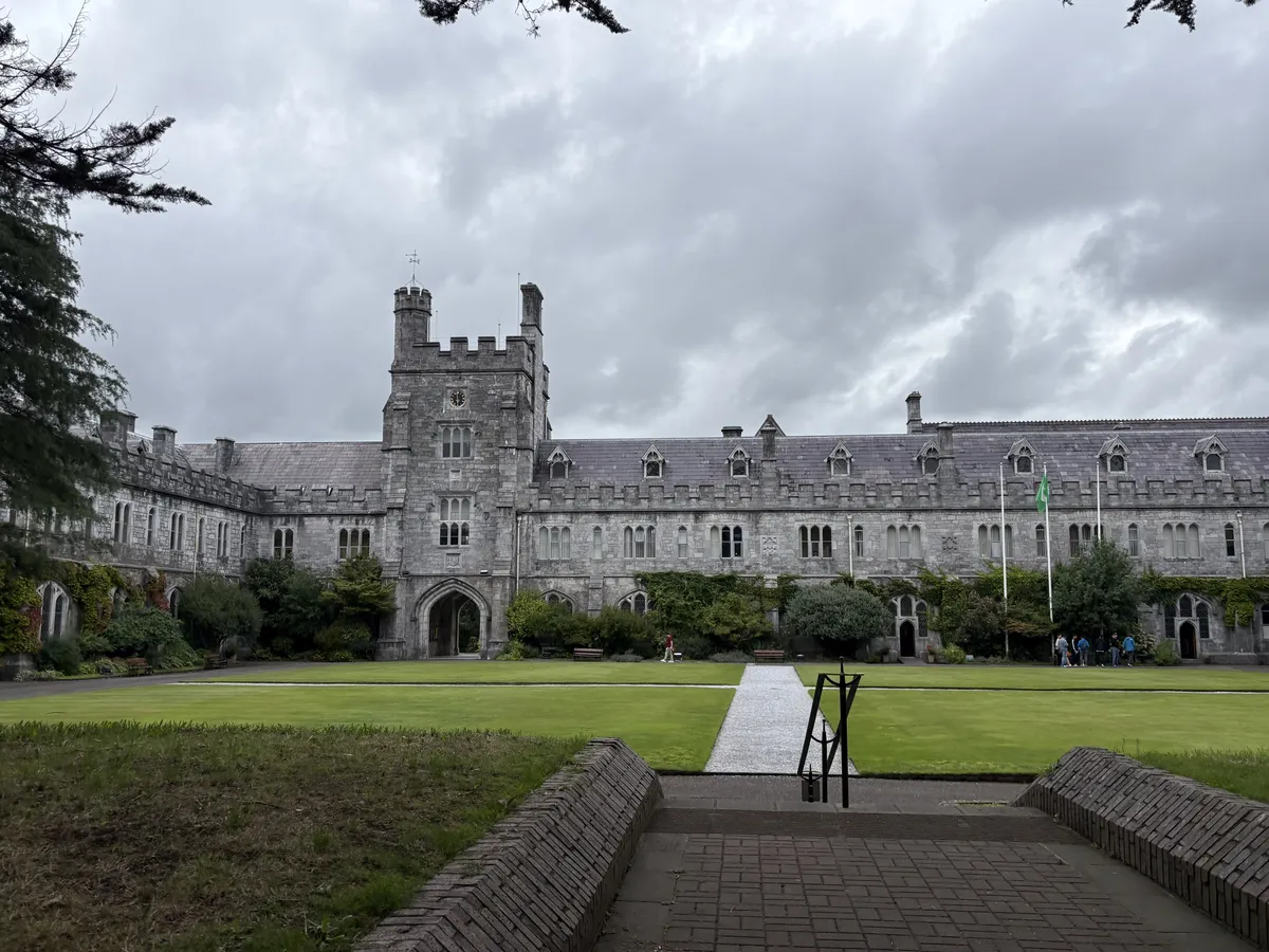 A castle-like college in Ireland—stone buildings and a green, green grass quad.