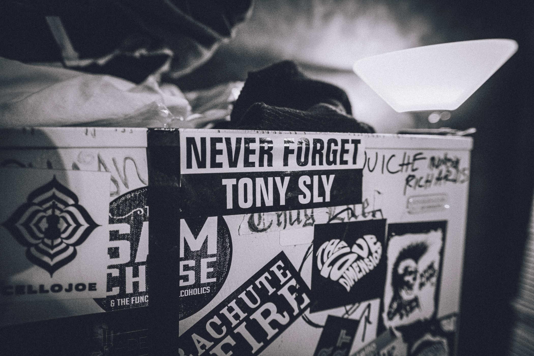 A bunch of stickers on a white surface but the most prominent reads NEVER FORGET TONY SLY