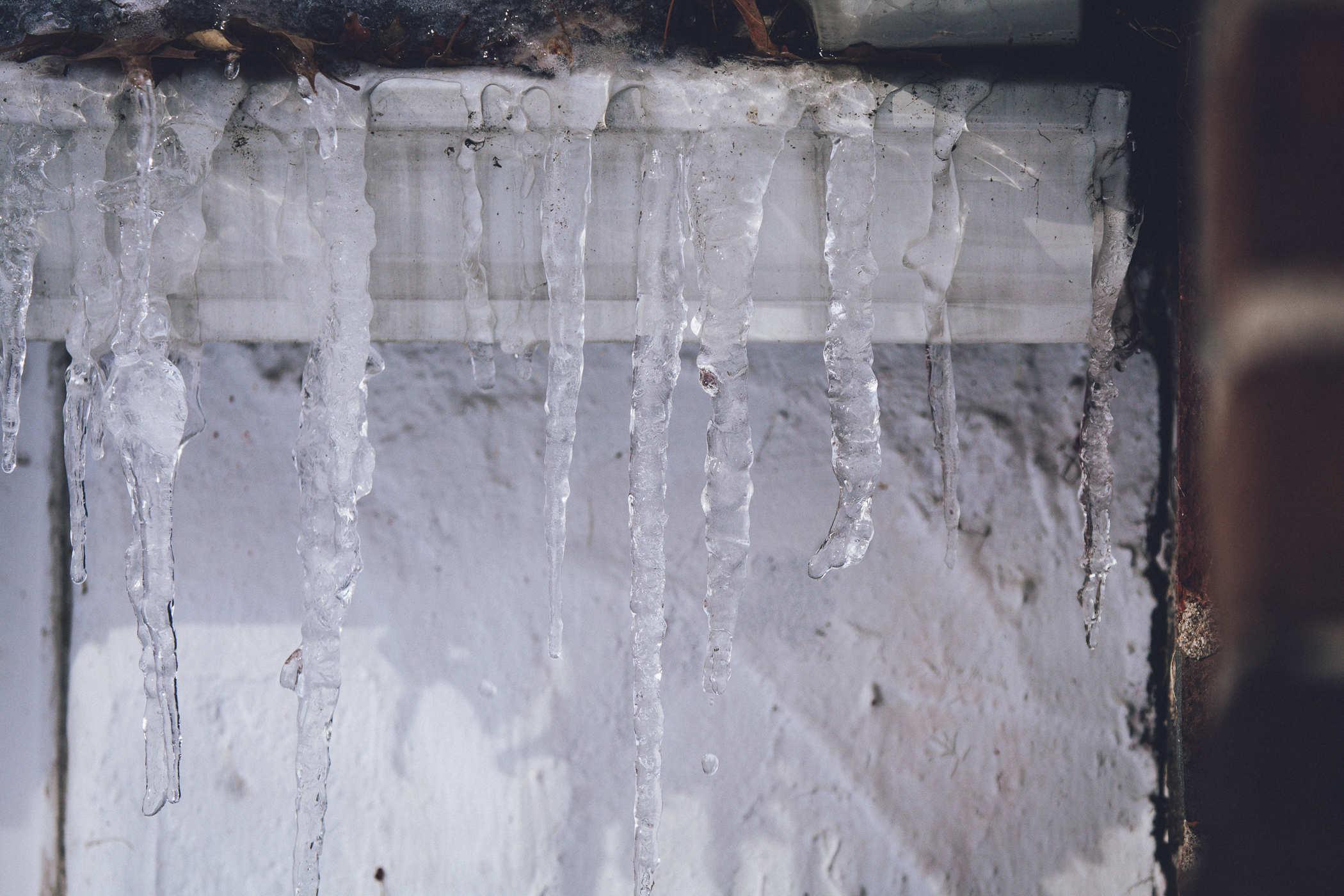 Photo of icicles in front of a window