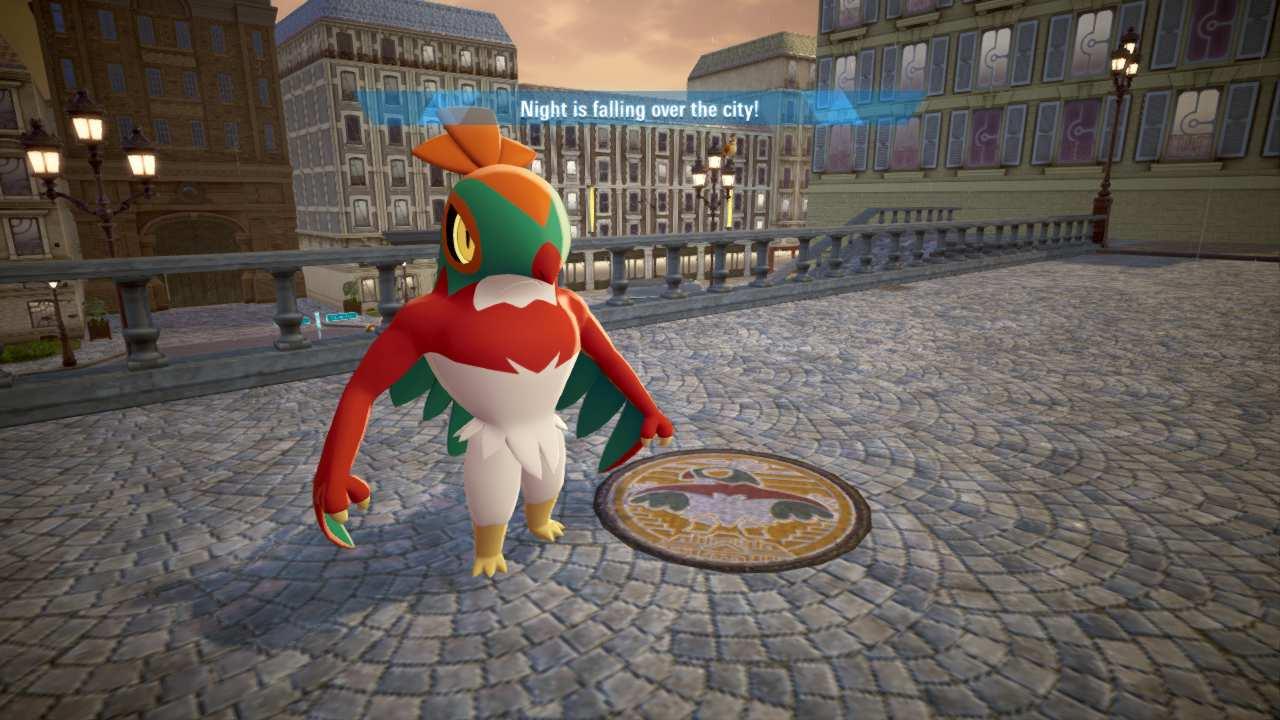 Photo of a Hawlucha, a biped bird man pokemon with face colors like a luchador mask; they are standing next to a sewer cap that has the same pokemon design painted on it