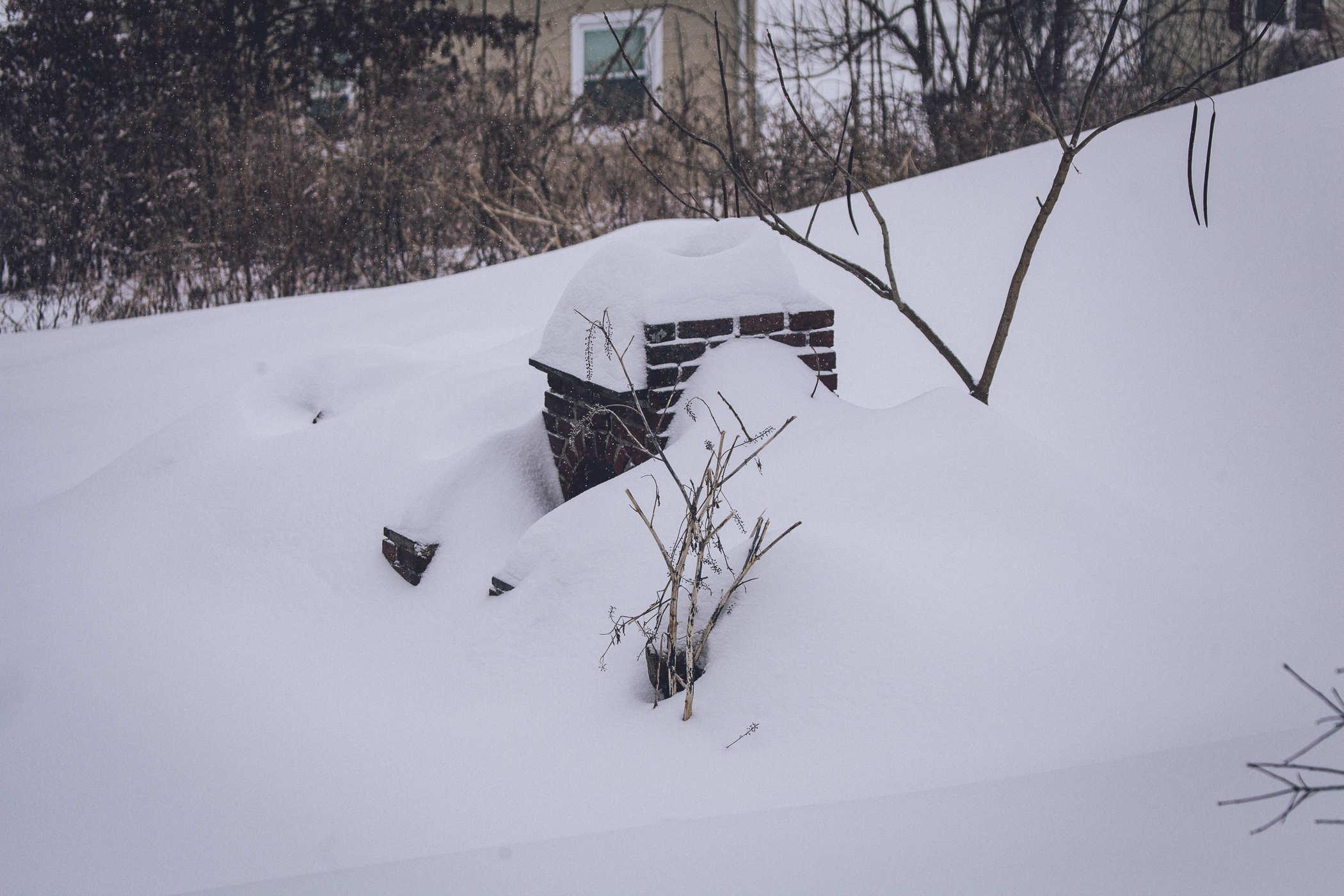 the structure is almost unrecognizable; most of it is buried in snow