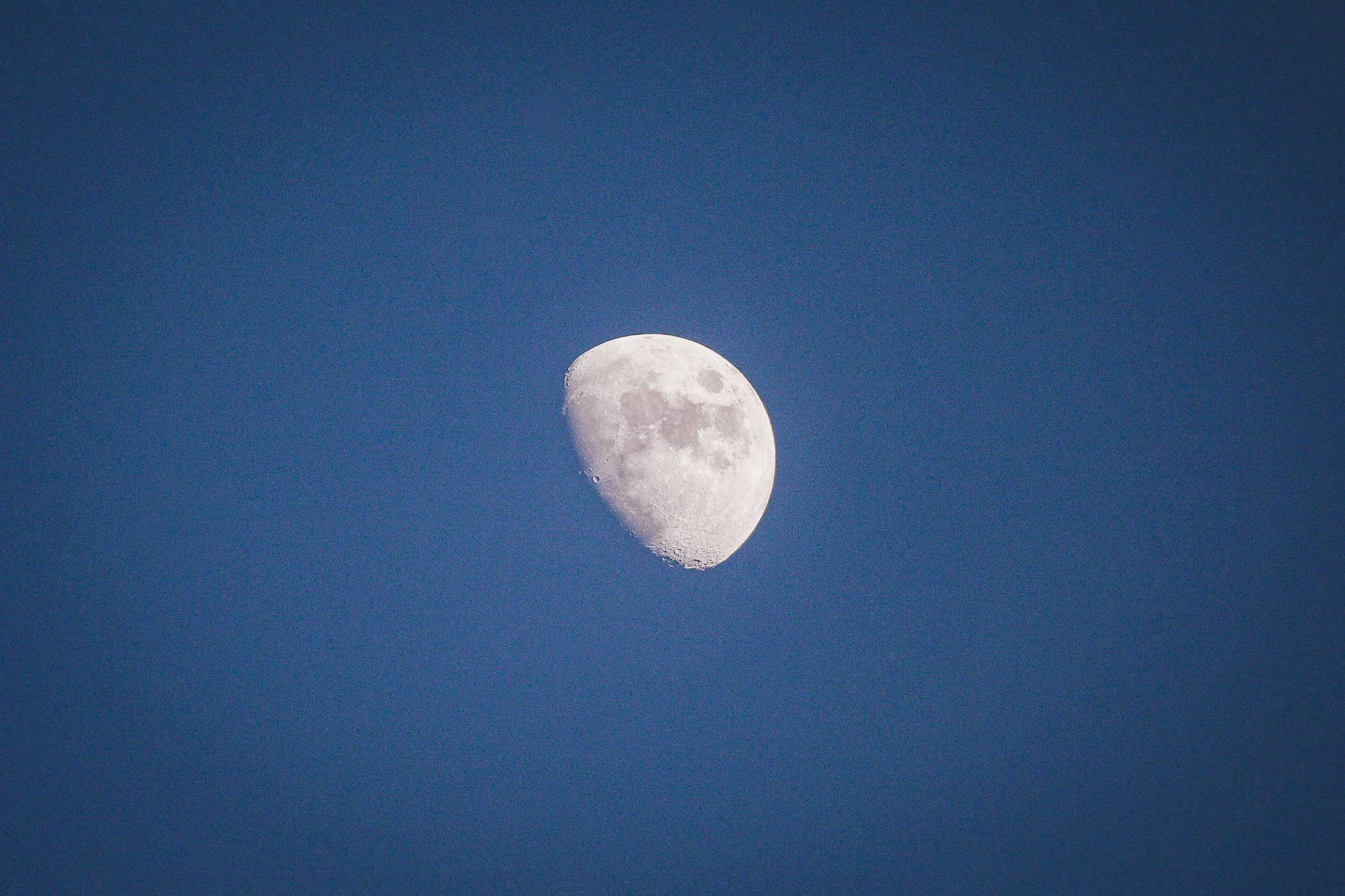 Photo of a waning gibbous moon in daylight