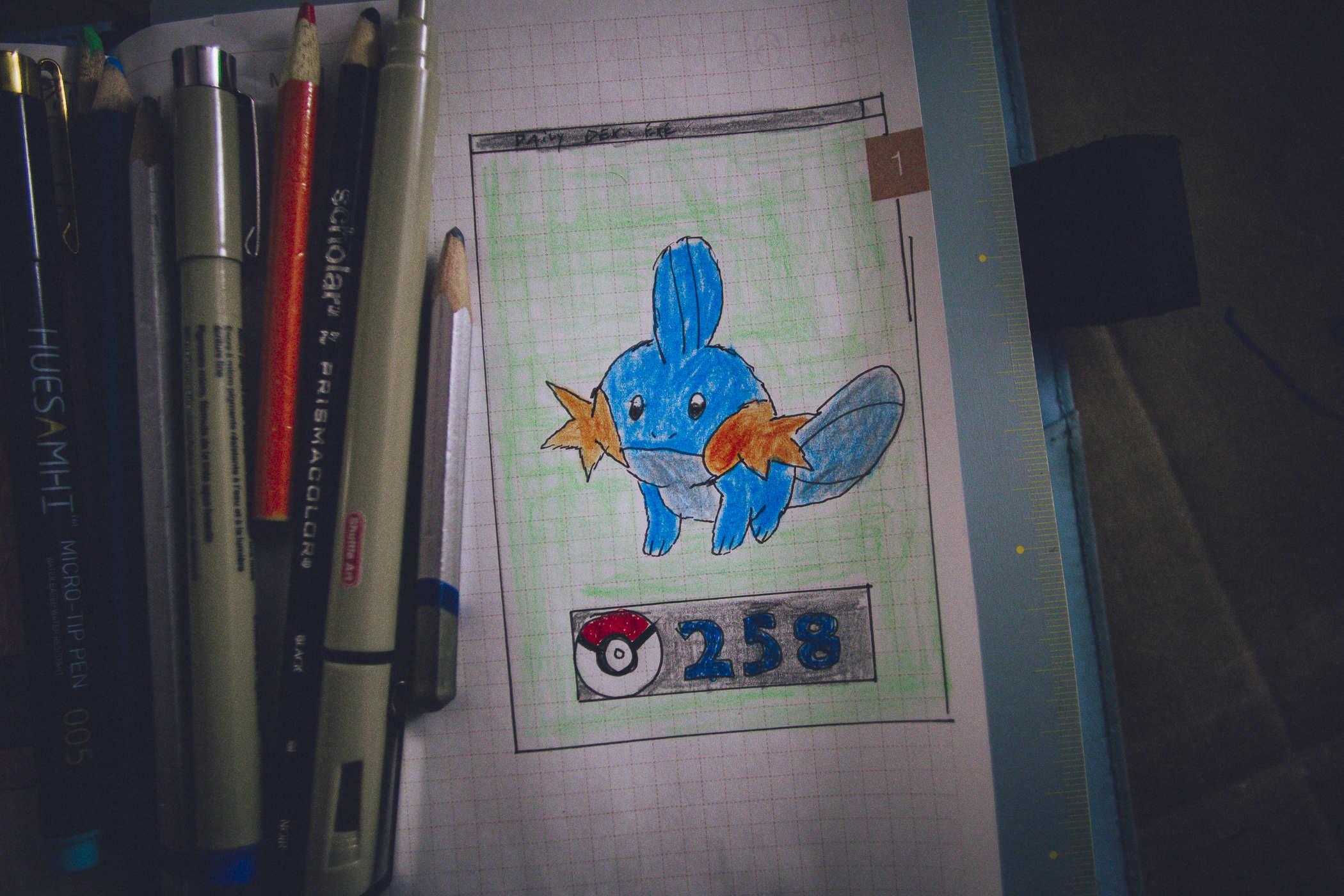 Drawing of pokemon 258; a blueish axolotl like creature with orange, star shaped side fins on the face