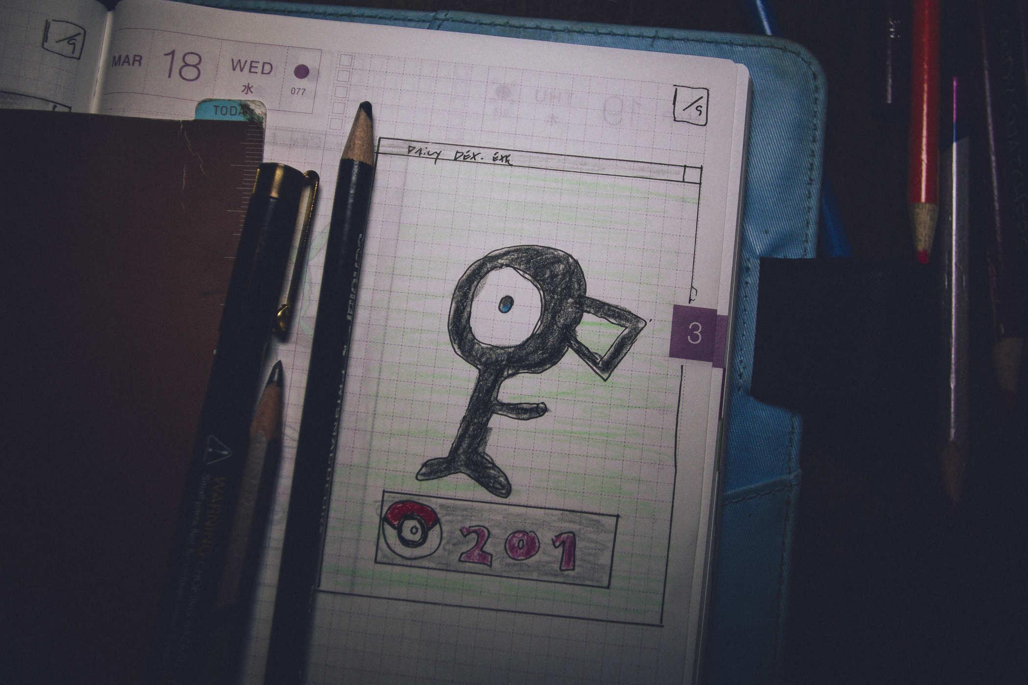Drawing of pokemon 201; the F variant of Unown, a large eyeball with black shape around it in the form of an F