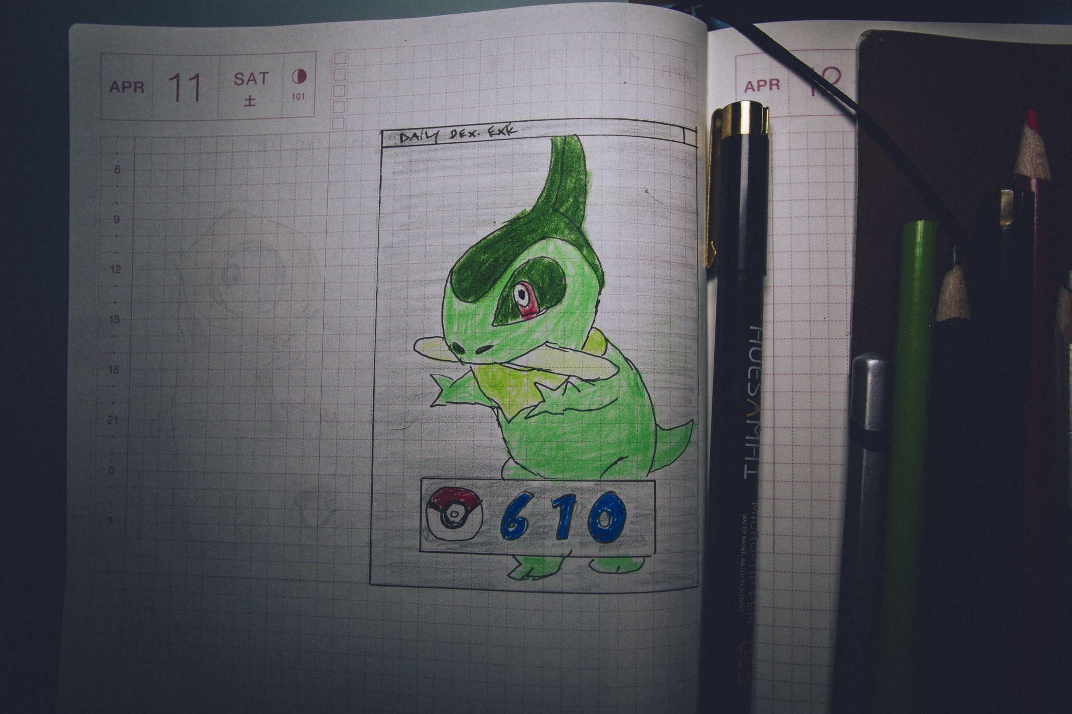 Drawing of pokemon 610; a small green dinosaur holding what looks like a nail file in its mouth