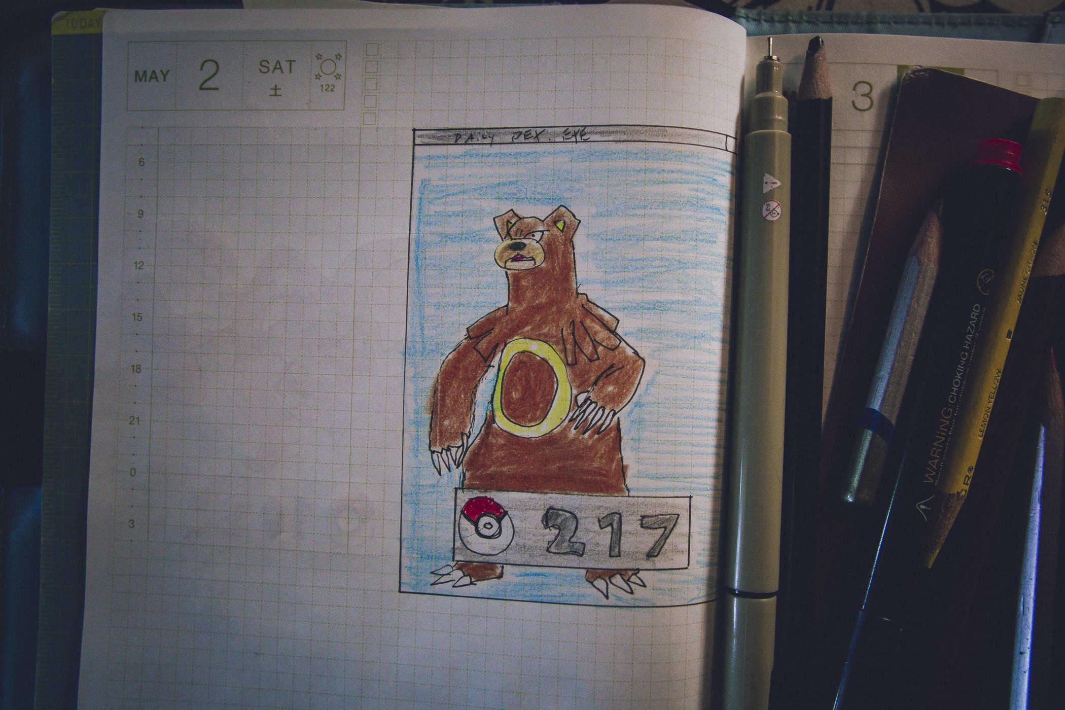 Drawing of pokemon 217; a large brown bear standing on hind legs and a yellow ring on its belly