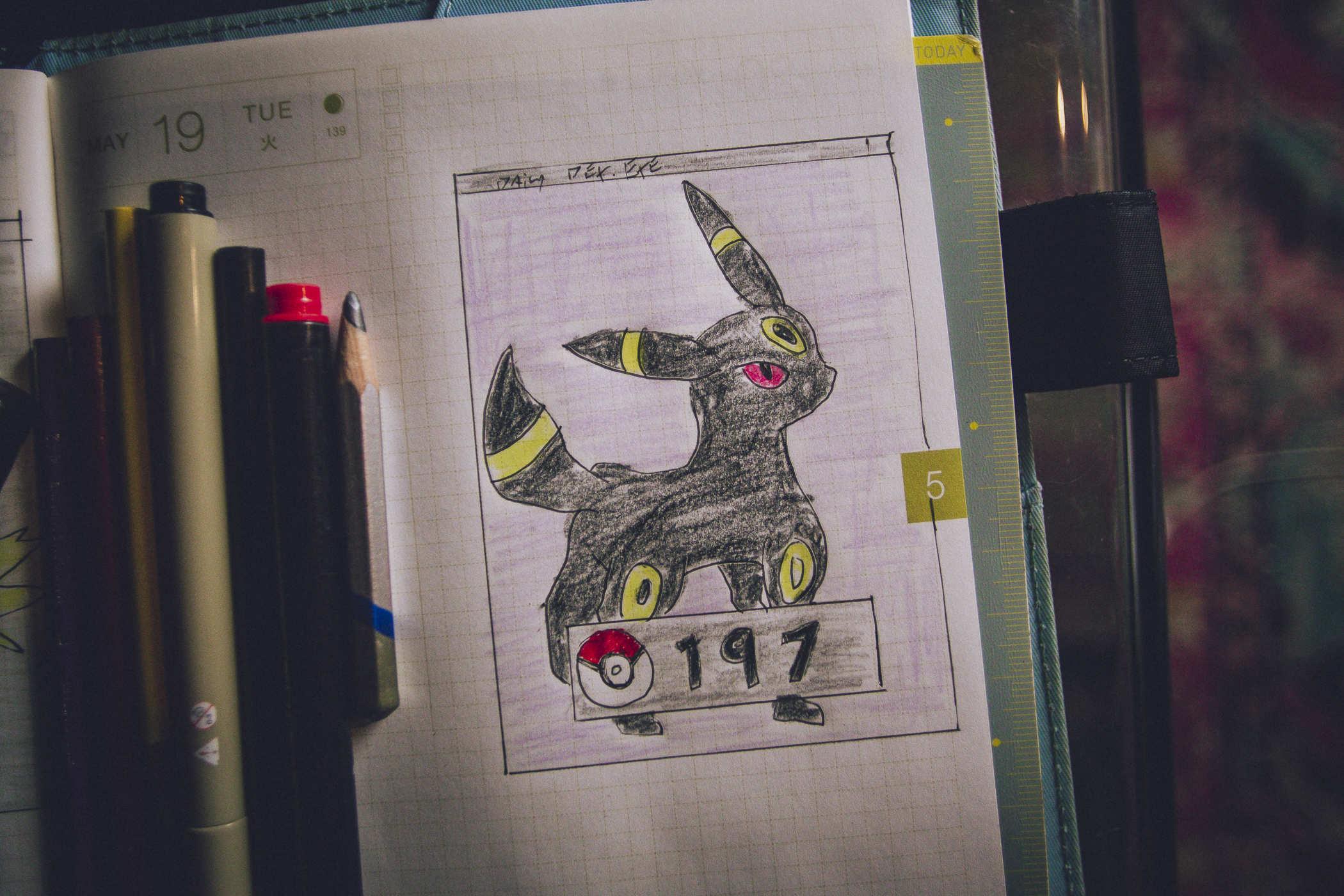 Drawing of pokemon 197; a mostly black rabbit cat creature with yellow ring designs on the head and sides 